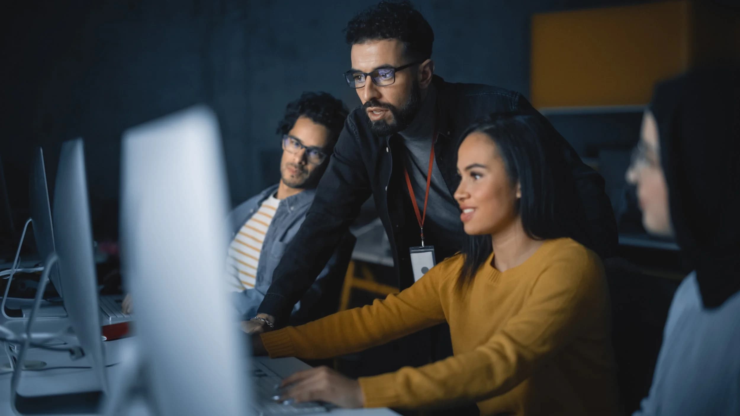 A team gathered around a computer during a training session